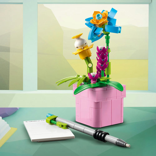 Flowerpot, pen and notebook